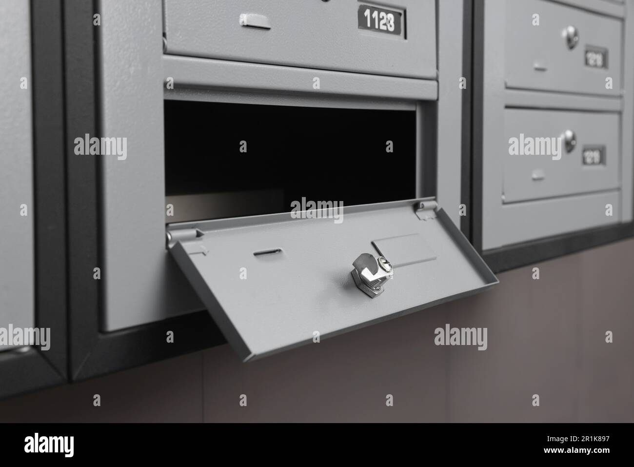 Open empty metal mailbox with keyhole indoors Stock Photo - Alamy
