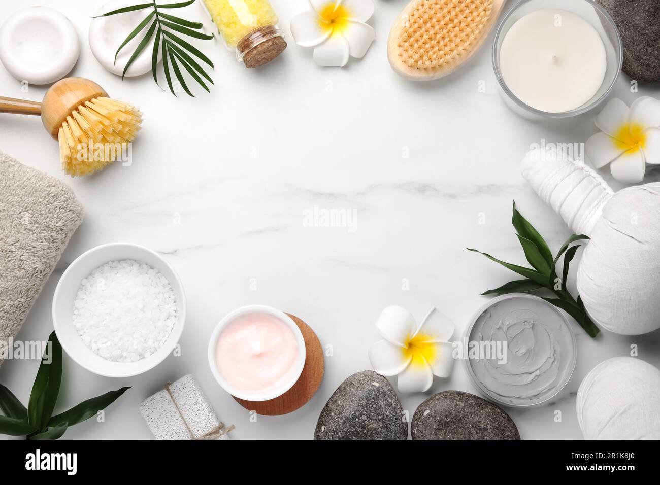 Flat lay composition with different spa products on white marble table ...