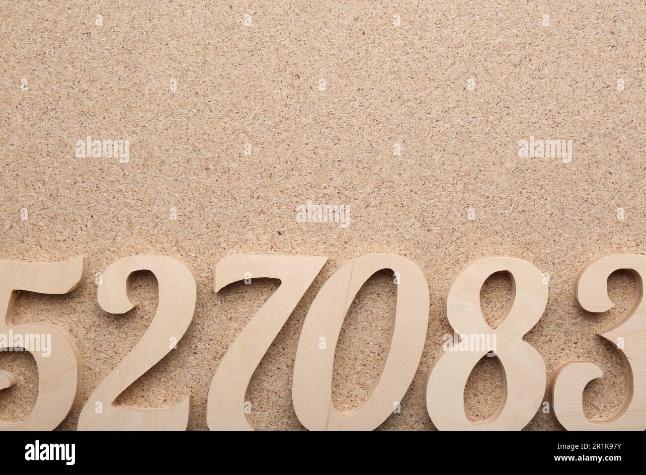 Wooden numbers on fiberboard, flat lay. Space for text Stock Photo - Alamy