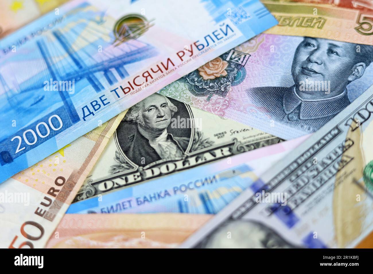 US dollars, Chinese yuan, Euro banknotes and Russian rubles. Concept of trade war between the China and USA Stock Photo