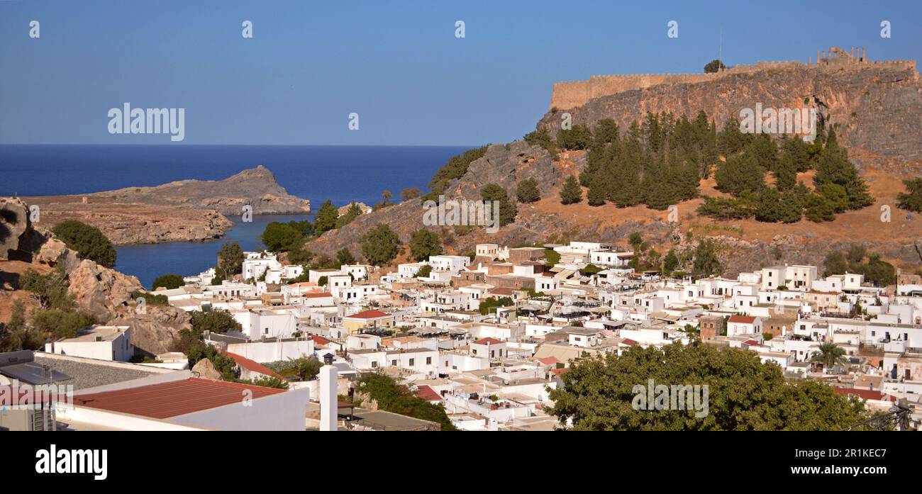 Panorama of the Greek village of Lindos with white houses and green ...