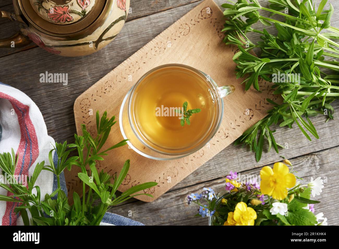 A cup of herbal tea with fresh cleavers plant, top view Stock Photo Alamy