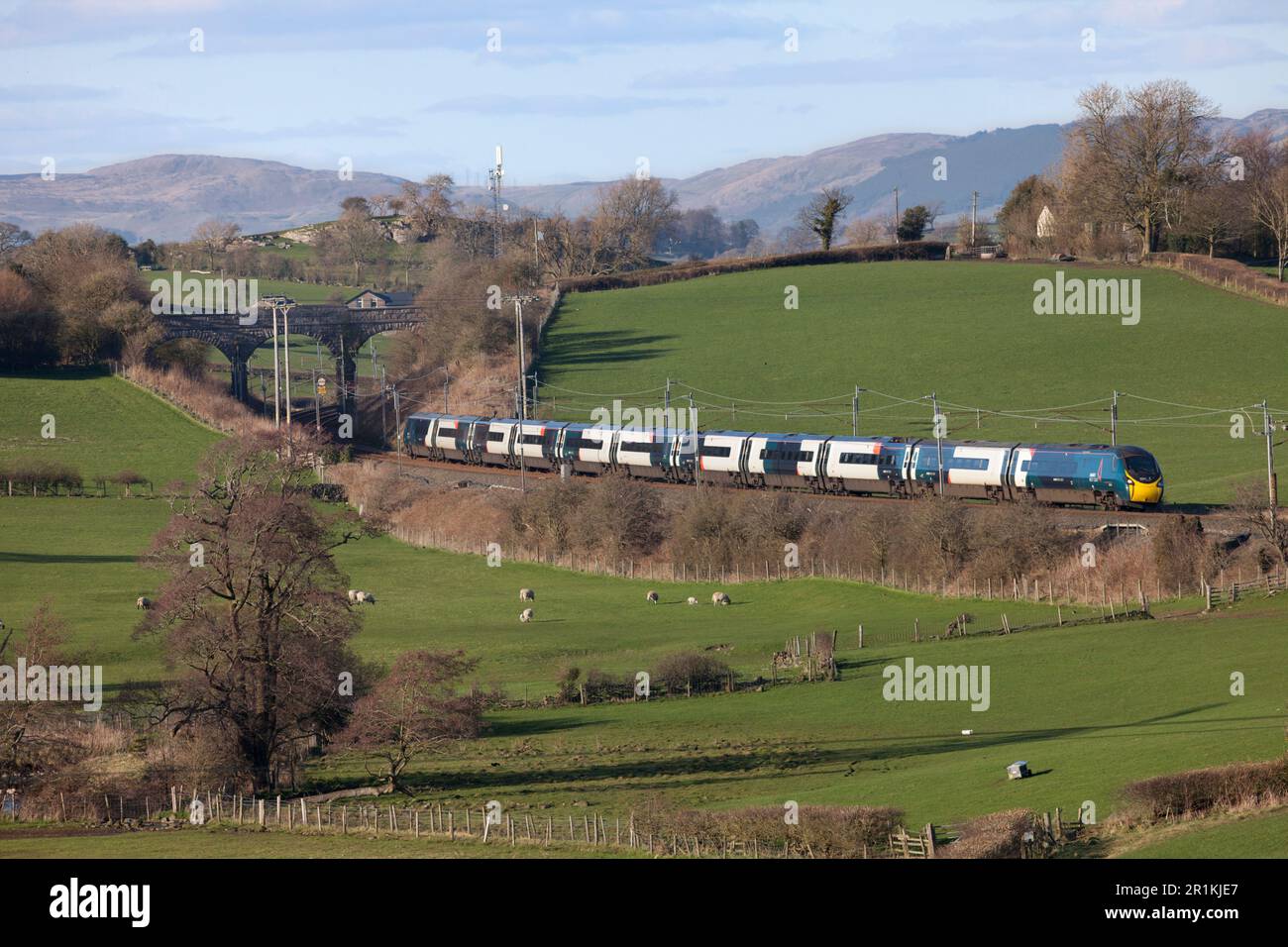 Avanti West Coast Alstom Pendolino train passing the Cumbria countryside on the west coast mainline Stock Photo