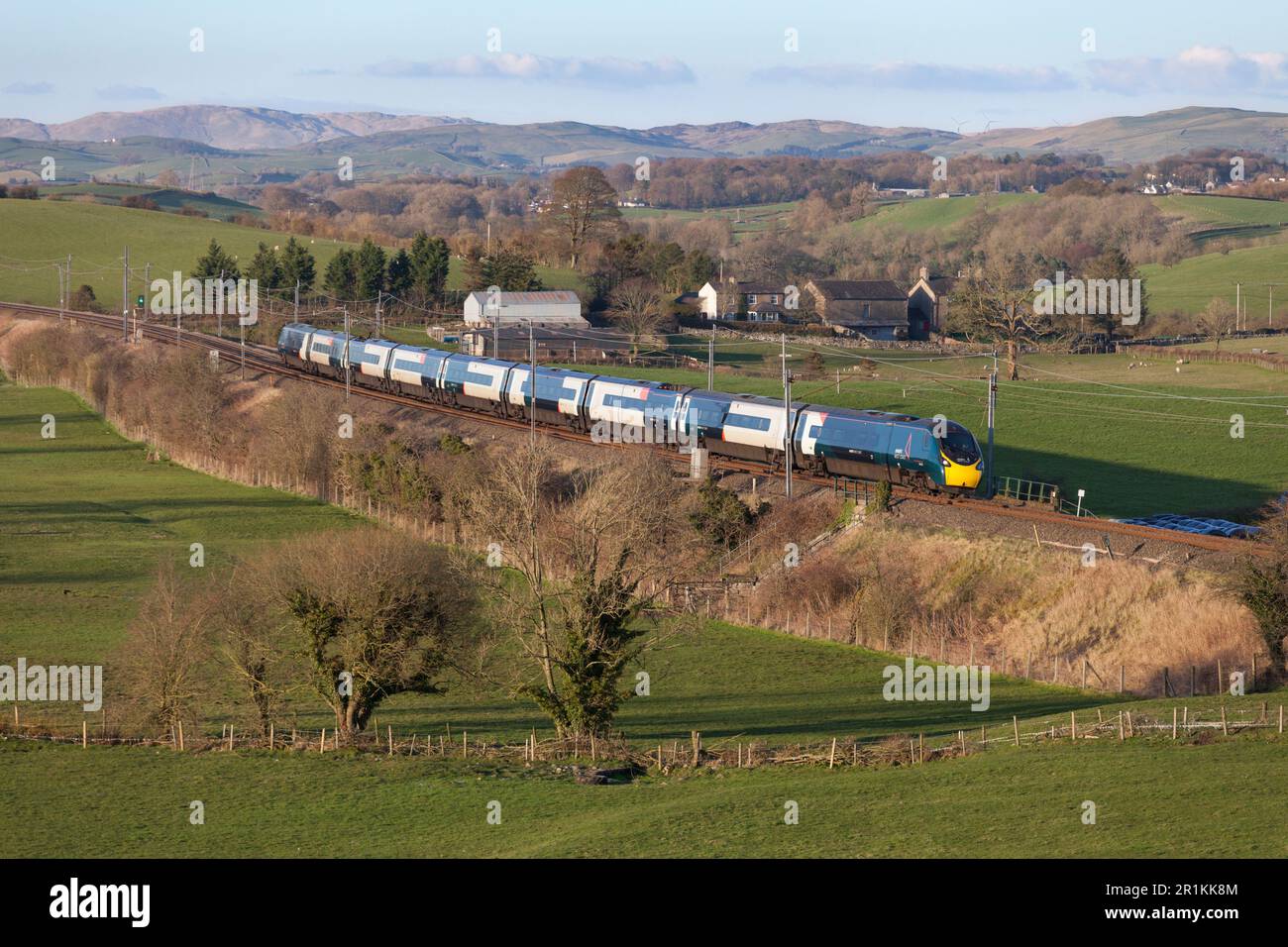 Avanti West Coast Alstom Pendolino train passing the Cumbria countryside on the west coast mainline Stock Photo