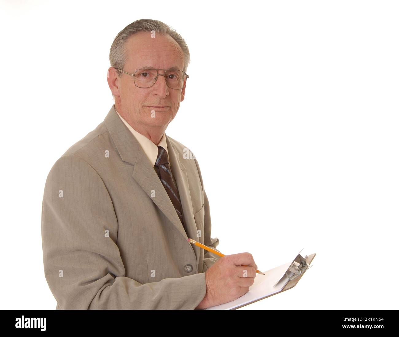 Senior businessman taking notes on a clipboard Stock Photo