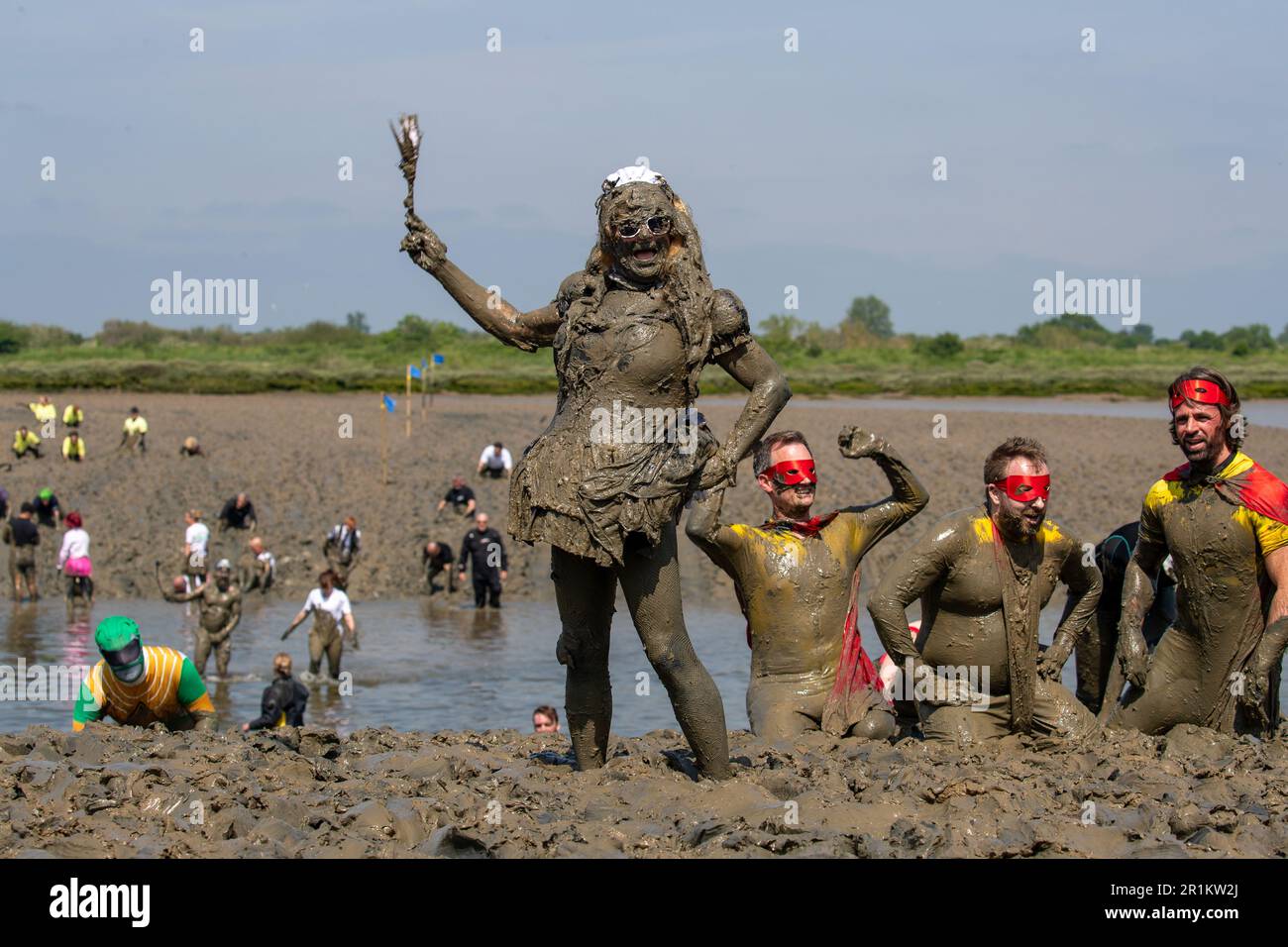 Maldon, Essex, UK. 14th May 2023. Competitors take part in the Maldon Mud Race, The mud race consists of a 500 meters dash across the River Blackwater and dates back to 1973. Credit: Lucy North/Alamy Live News Stock Photo