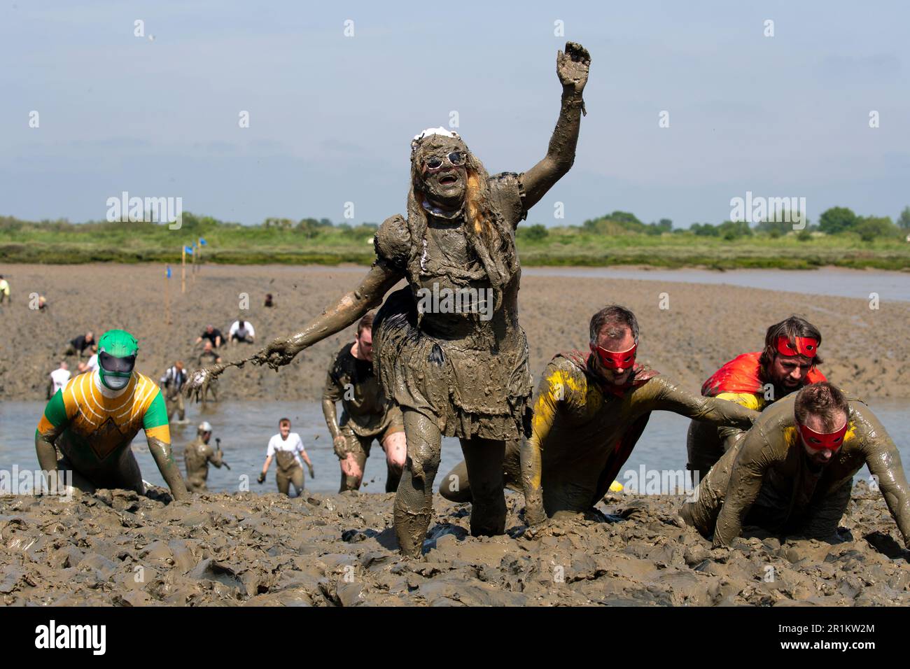 Maldon, Essex, UK. 14th May 2023. Competitors take part in the Maldon Mud Race, The mud race consists of a 500 meters dash across the River Blackwater and dates back to 1973. Credit: Lucy North/Alamy Live News Stock Photo