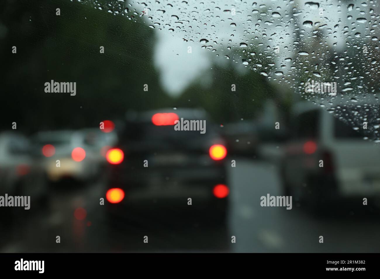 Blurred view of road through wet car window. Rainy weather Stock Photo ...