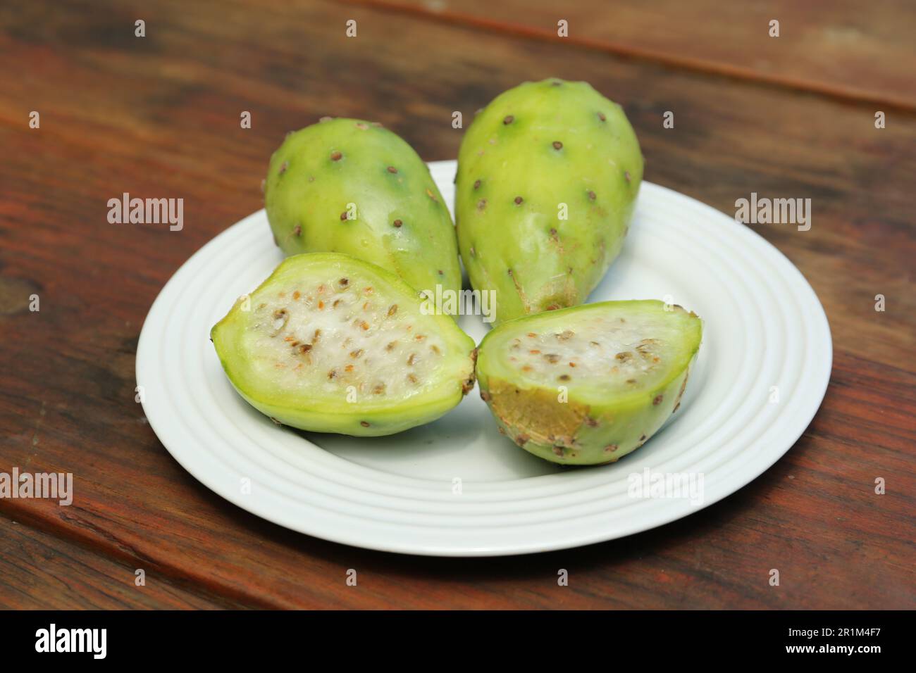 Tasty prickly pear fruits on wooden table Stock Photo