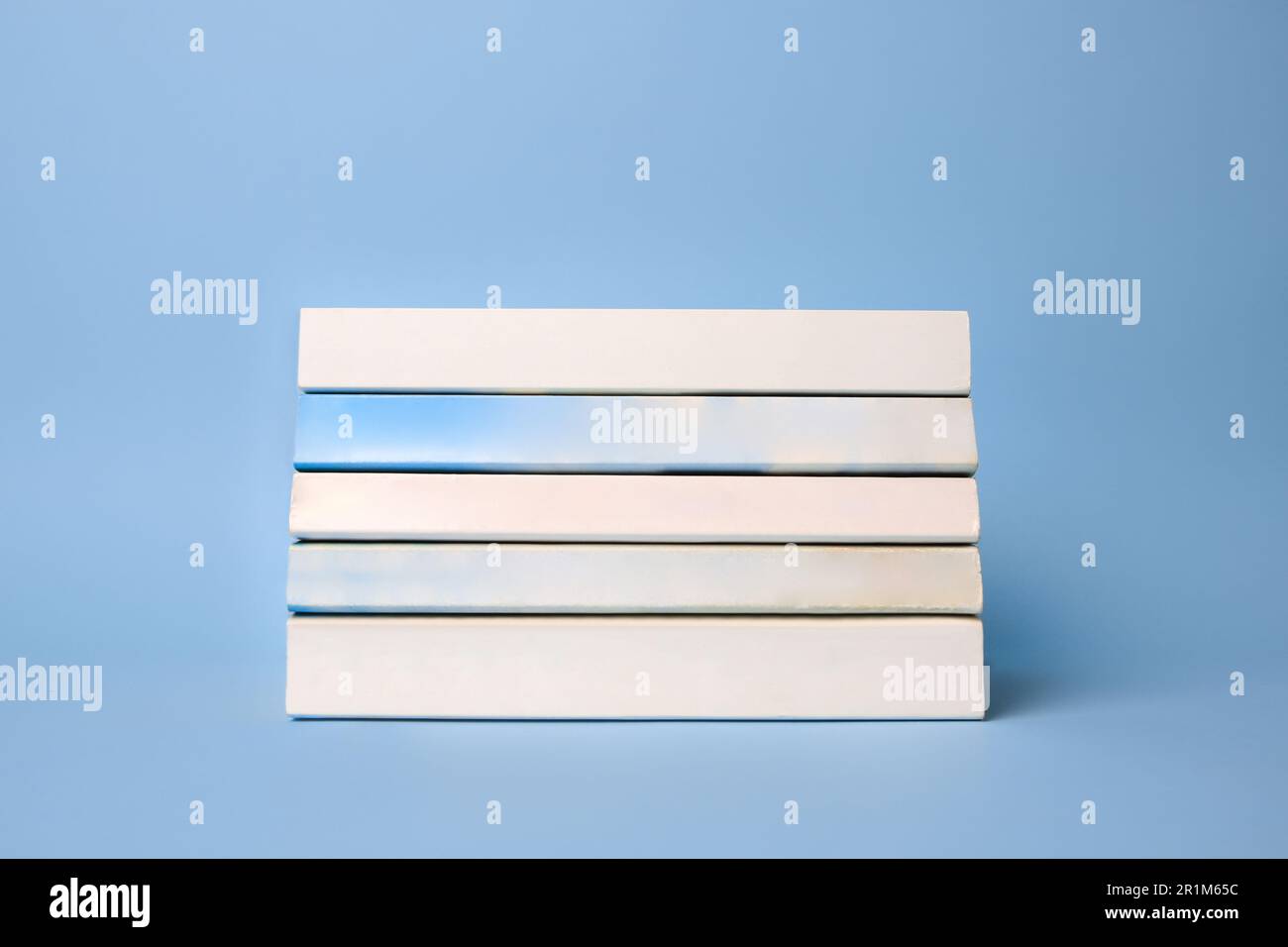 Collection of books on light blue background Stock Photo - Alamy