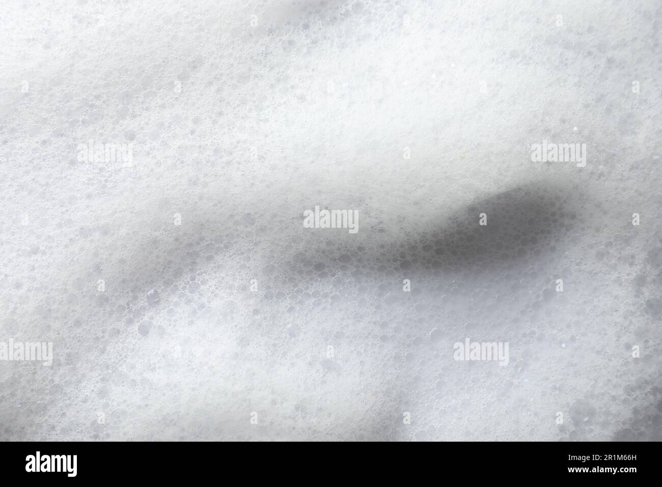 Fluffy bath foam on pink background, closeup. Care product Stock Photo