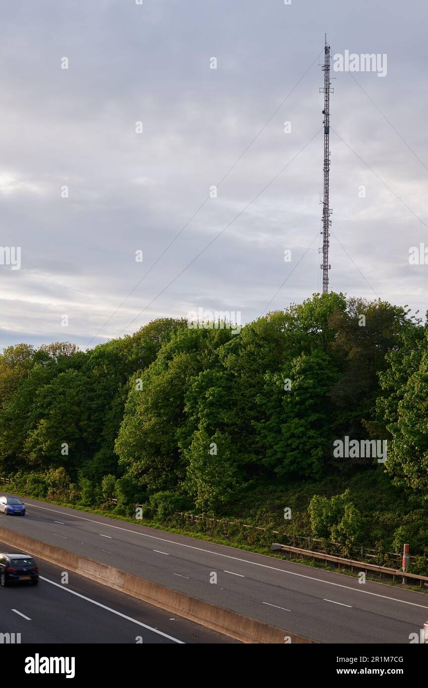 radio transmitter mast and motorway with passing cars Stock Photo