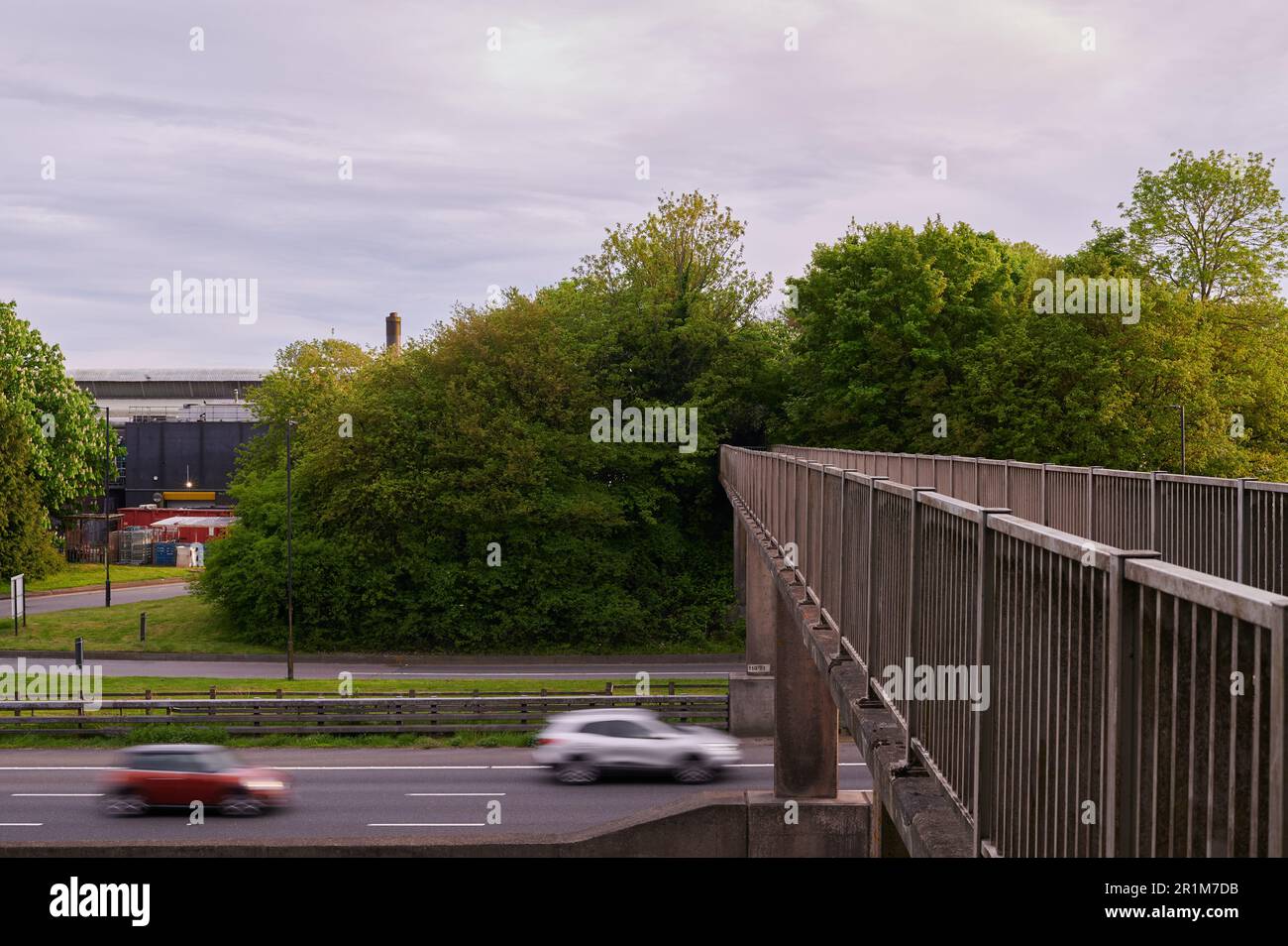 pedestrian bridge over motorway with motion blur of moving traffic Stock Photo