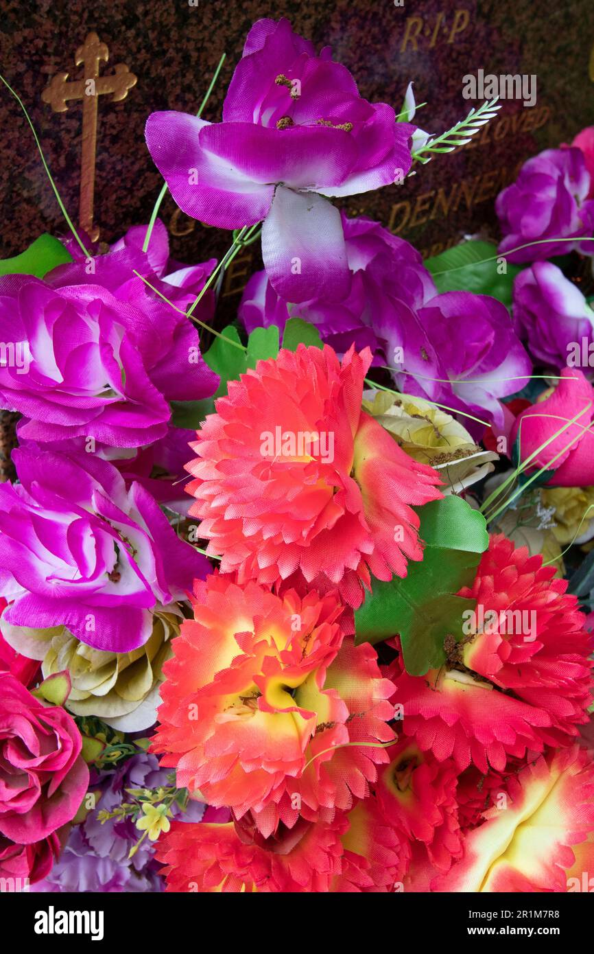 Artificial flowers on a grave in West Norwood Cemetery, one of London's