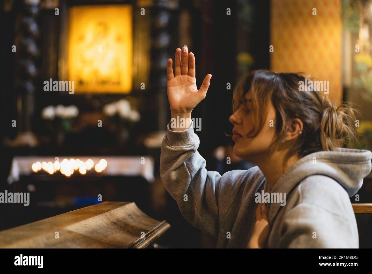 Woman praying on knees in light hi-res stock photography and images - Alamy