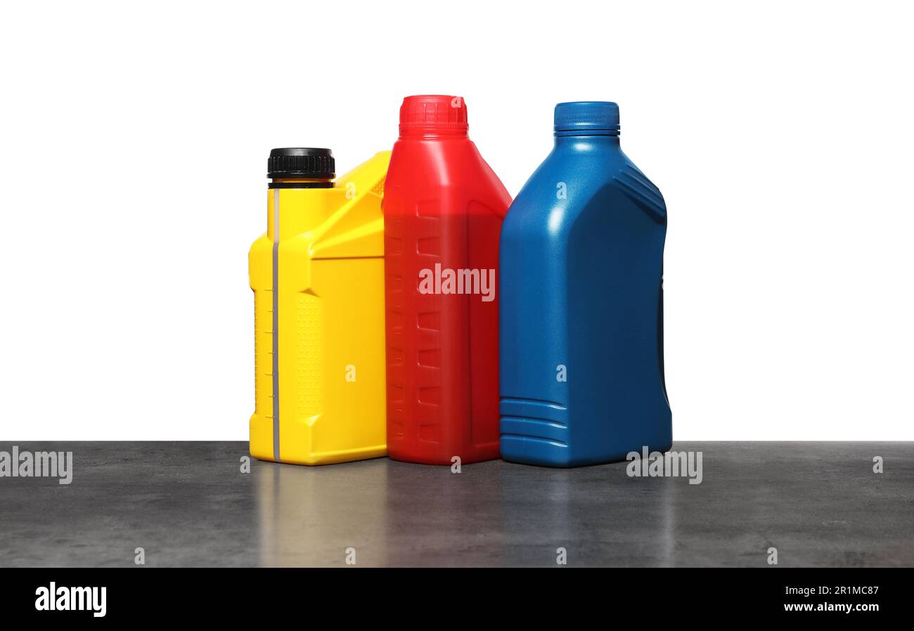 Motor Oil Container Color Motor oil in different containers on grey table against white ...