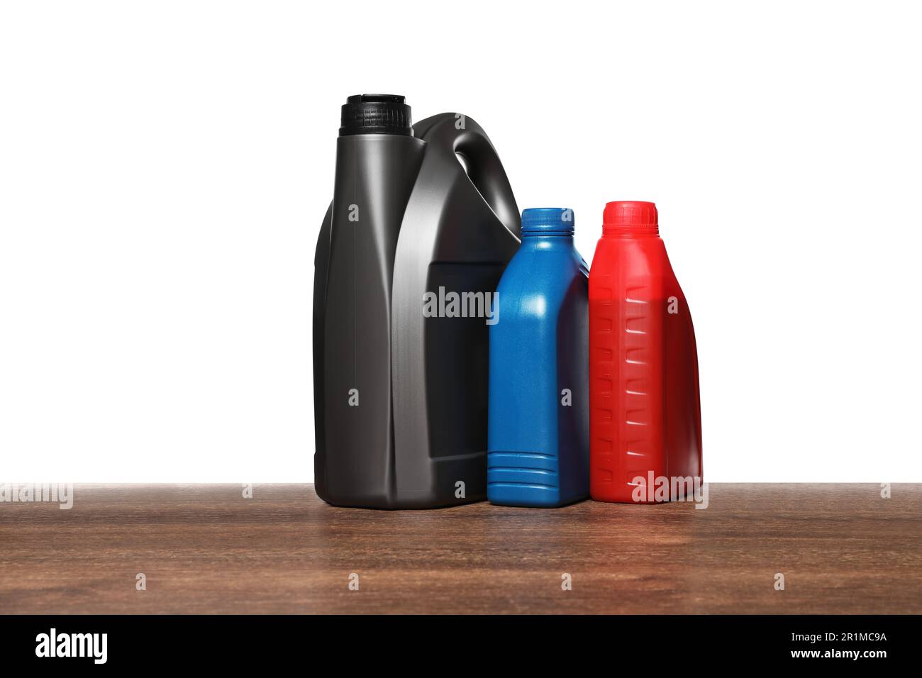 Motor Oil Container Color Motor oil in different containers on wooden table against white ...