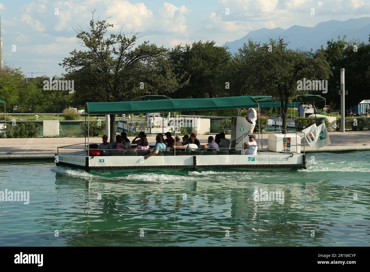 Monterrey, Mexico - September 11, 2022. Tourist boat with people on canal in Parque Fundidora Stock Photo