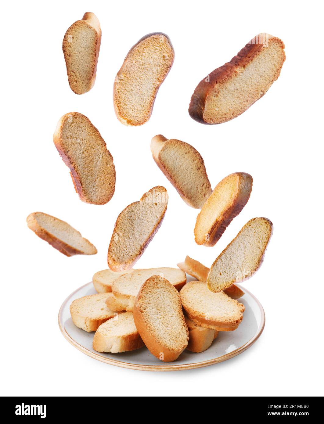 Hard chuck crackers falling into plate on white background Stock Photo