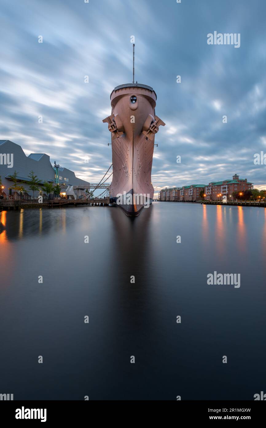 NORFOLK, VIRGINIA, USA - MAY 10, 2023: The USS Wisconsin (BB-64) located at the maritime themed museum Nauticus at dusk. Stock Photo