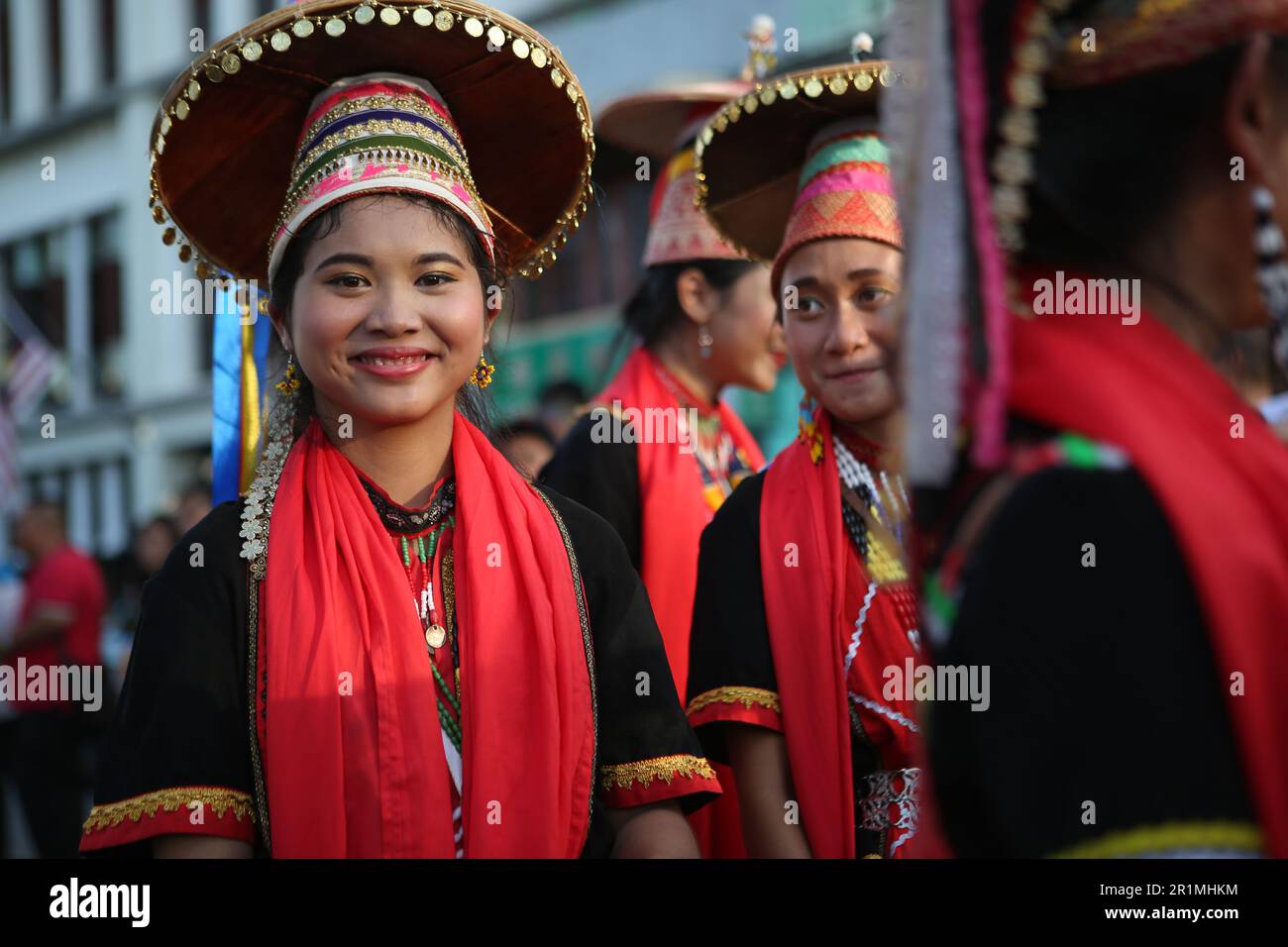 Charming Bidayuh girl with her team in traditional dress, Kuching, Sarawak, Malaysia, Borneo