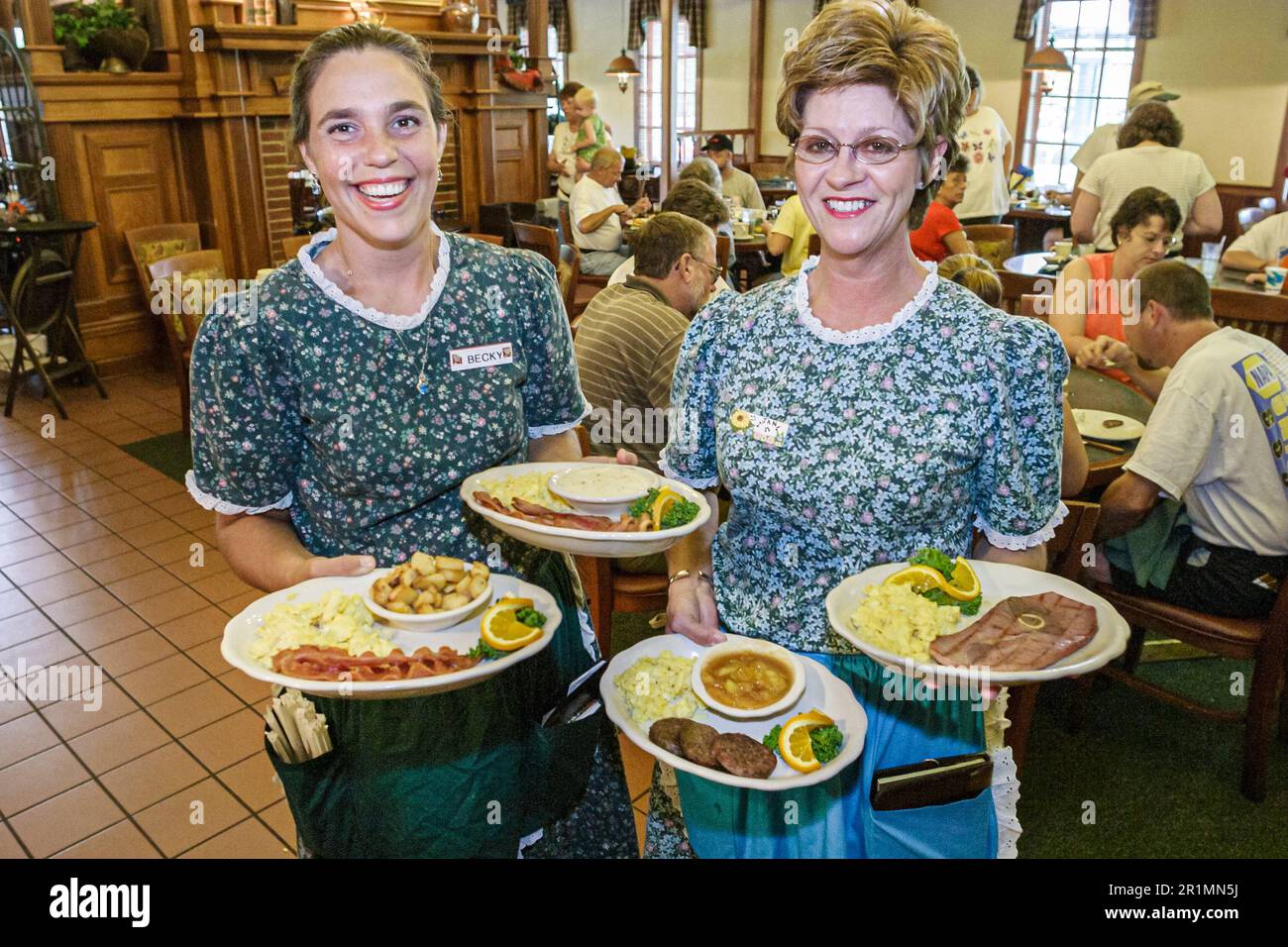 Sevierville Tennessee,dining Applewood Farmhouse Grill & restaurant,inside interior waitress server servers woman female women,serving plates food din Stock Photo