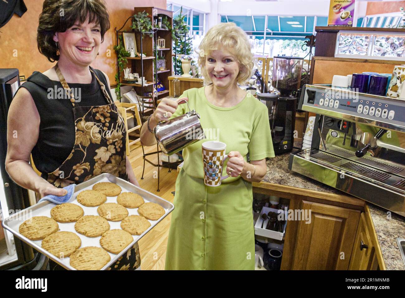 Sevierville Tennessee,coffee shop cafe small business,woman female women owner owners friends,inside interior serve serving cookies Stock Photo