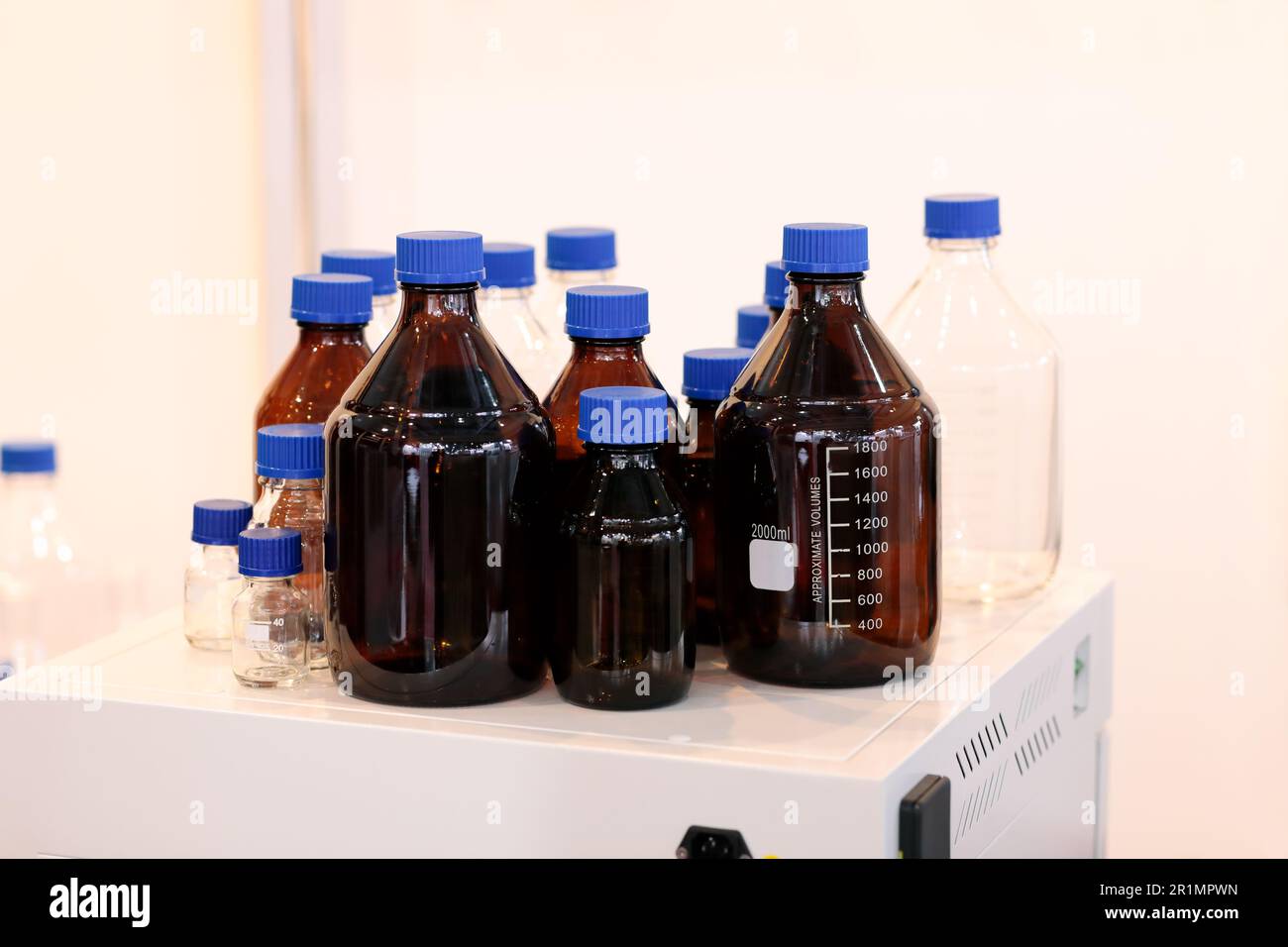 Empty glass reagent bottles in chemical laboratory. Selective focus