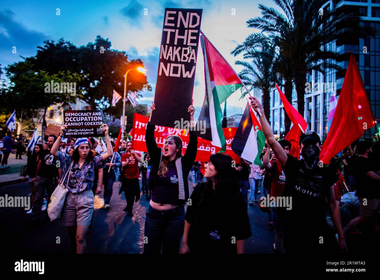 Tel Aviv, Israel. 13th May, 2023. Israeli protestors hold placards and Palestinian flags during an anti war demonstration. Israel and Islamic Jihad agreed to a ceasefire Saturday, after days of violence that have claimed the lives of at least 34 Palestinians and one Israeli. Credit: SOPA Images Limited/Alamy Live News Stock Photo