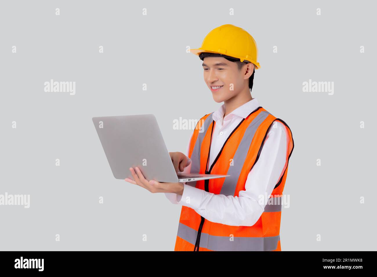 Portrait young asian engineer man looking laptop computer for planning ...