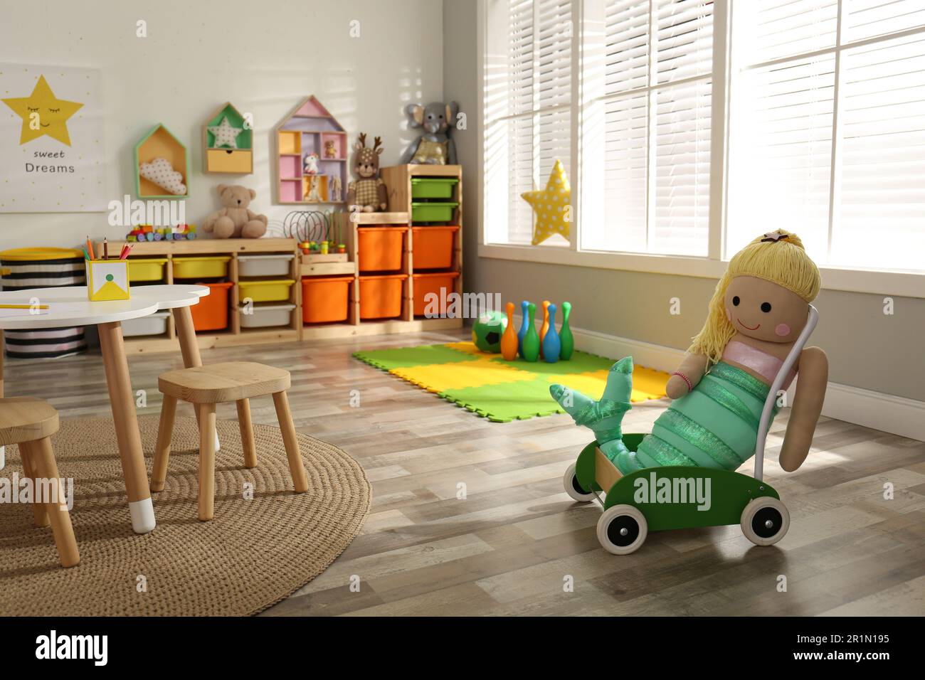Stylish playroom interior with soft toys and modern furniture Stock Photo
