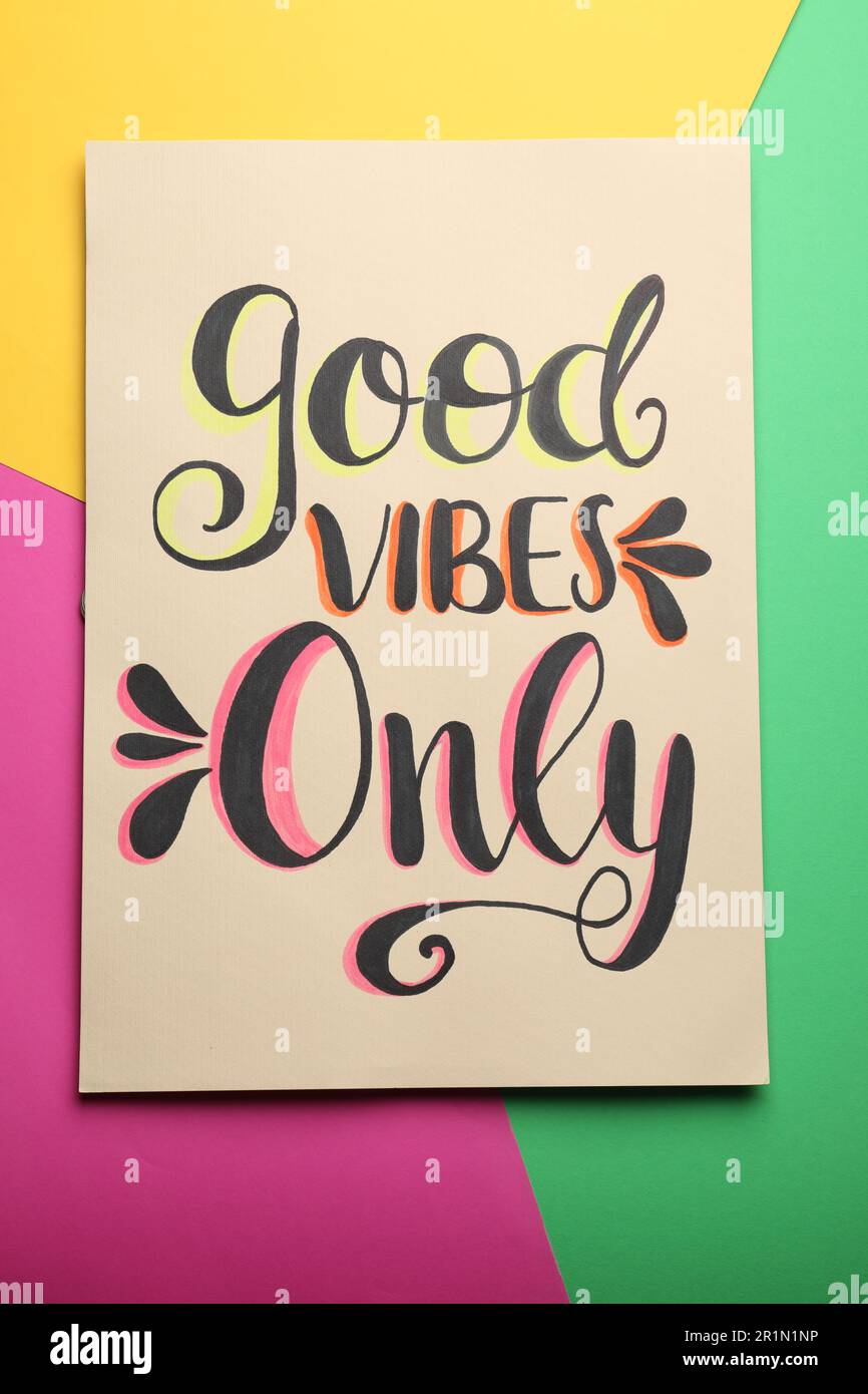 Card with life-affirming phrase Good Vibes Only on colorful background, top view Stock Photo