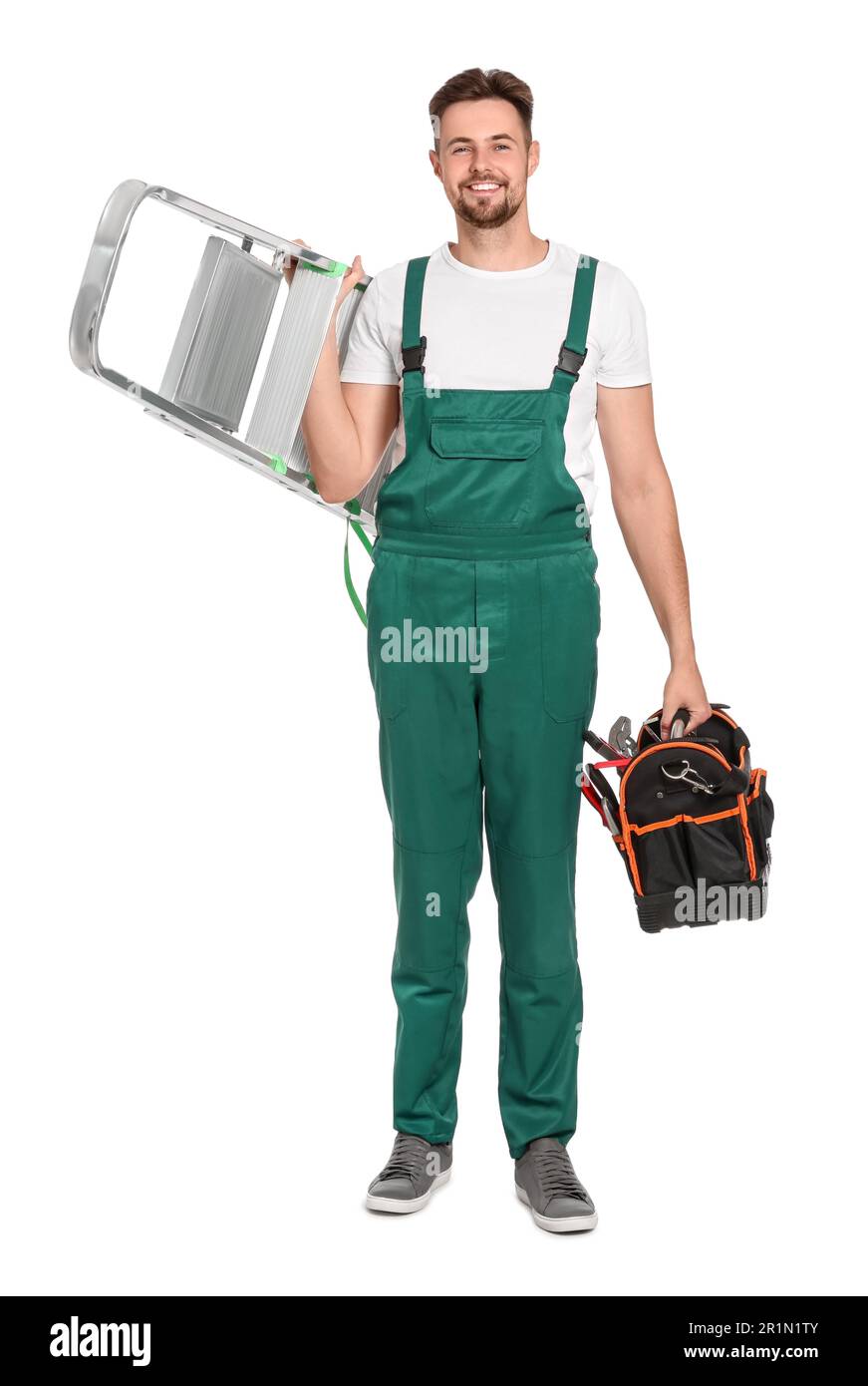 Worker in uniform holding metal ladder and instruments on white ...