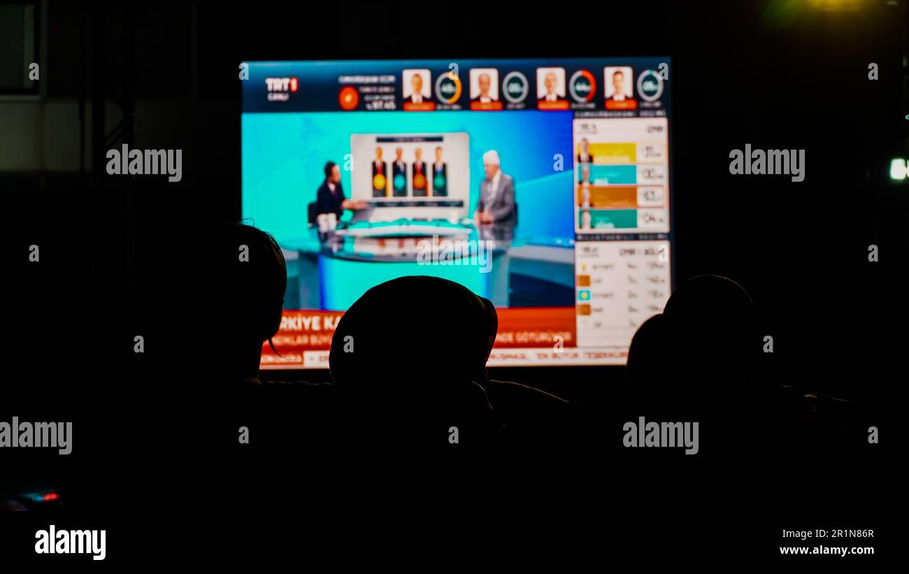Izmir, Turkey. 15th May, 2023. AK Party supporters are watching live updates of the Turkish 2023 General Elections at midnight in front of the AK Party Izmir Provincial Presidency. Erdogan leads with 49.49% of the vote, Kilicdaroglu takes 44.79% of the vote after 91.93% of ballots were counted, the head of Turkey's Supreme Election Council said in early Monday. (Photo by Idil Toffolo/Pacific Press) Credit: Pacific Press Media Production Corp./Alamy Live News Stock Photo