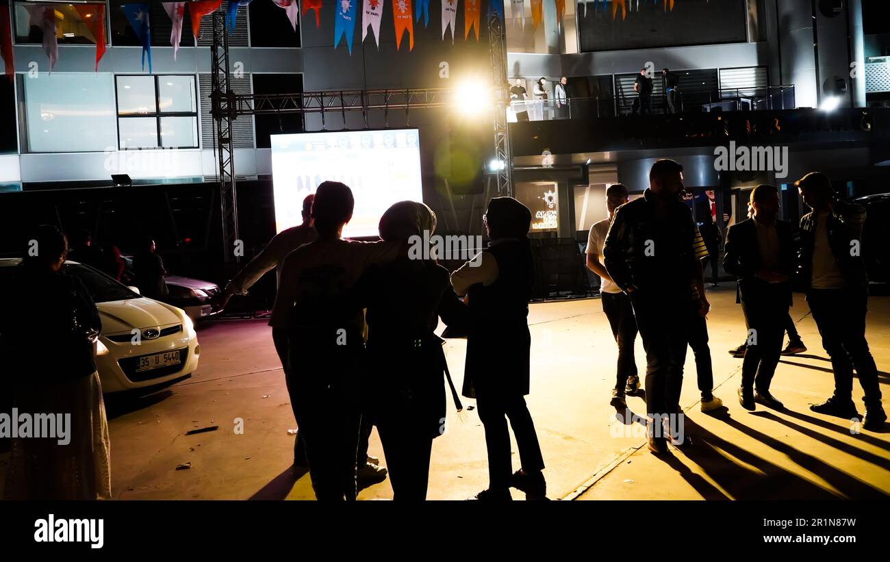 Izmir, Turkey. 15th May, 2023. AK Party supporters are watching live updates of the Turkish 2023 General Elections at midnight in front of the AK Party Izmir Provincial Presidency. Erdogan leads with 49.49% of the vote, Kilicdaroglu takes 44.79% of the vote after 91.93% of ballots were counted, the head of Turkey's Supreme Election Council said in early Monday. (Photo by Idil Toffolo/Pacific Press) Credit: Pacific Press Media Production Corp./Alamy Live News Stock Photo