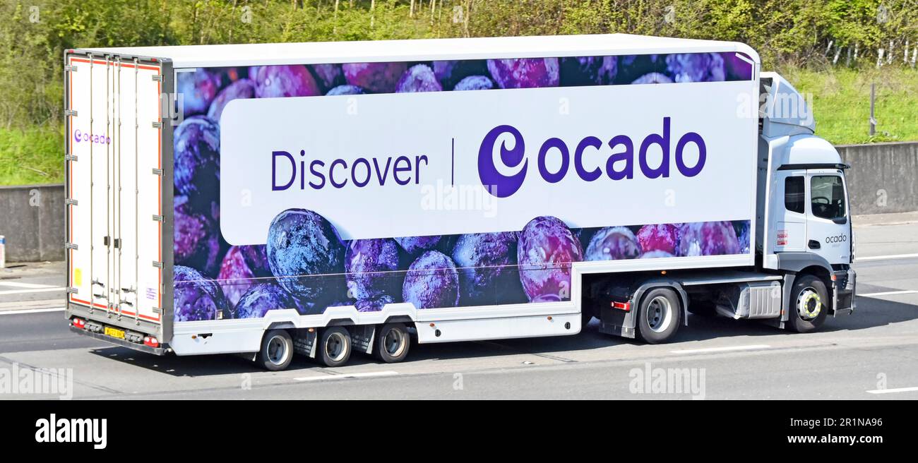 White hgv lorry truck power unit with aerodynamic deflector above cab  Discover Ocado banner across articulated semi trailer driving M25 motorway UK Stock Photo