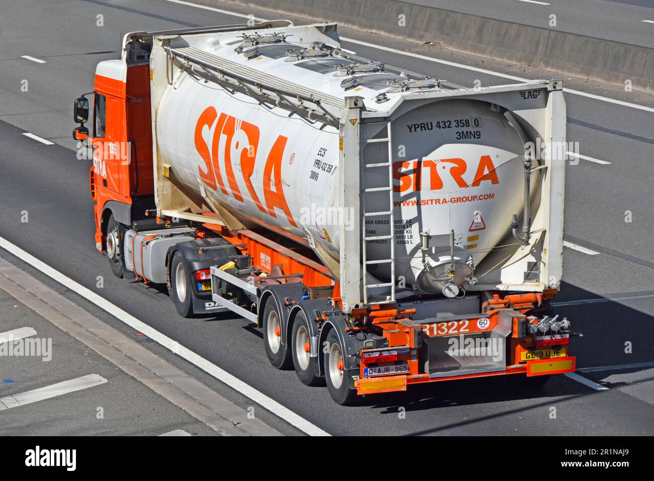 Side back rear aerial view Sitra logo on DAF tanker hgv lorry truck part of a supply chain transport specialist business driving along m25 motorway UK Stock Photo