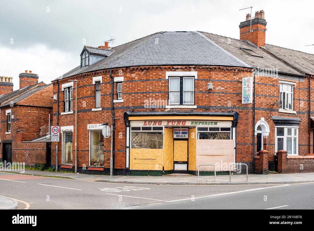 Closed down and boarded up Lung Fung Emporium, chinese takeaway in Crewe Cheshire UK Stock Photo