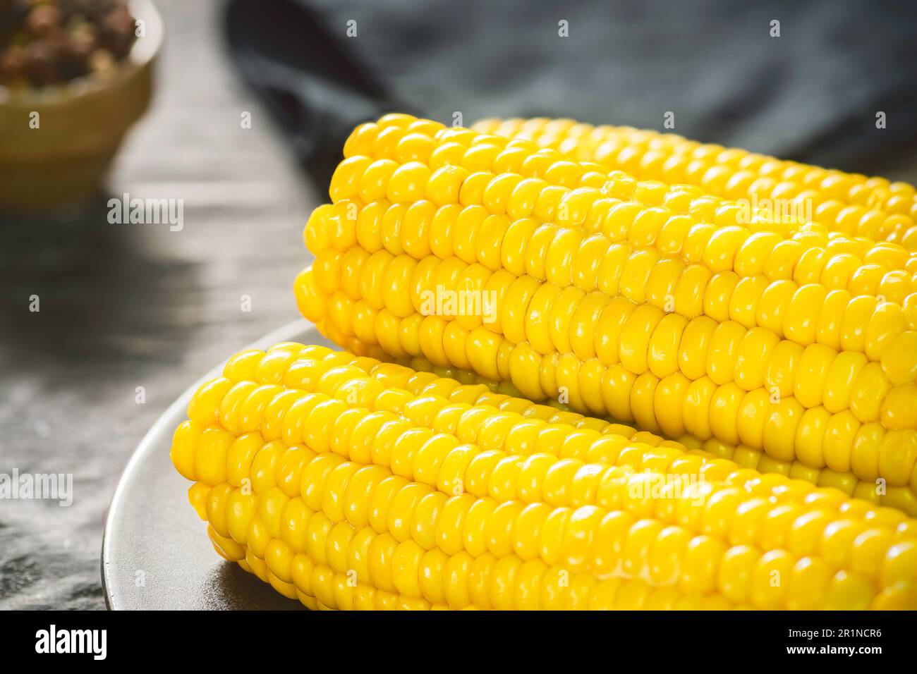 Delicious corn on the cob with melted butter. Close up with copy space. Stock Photo