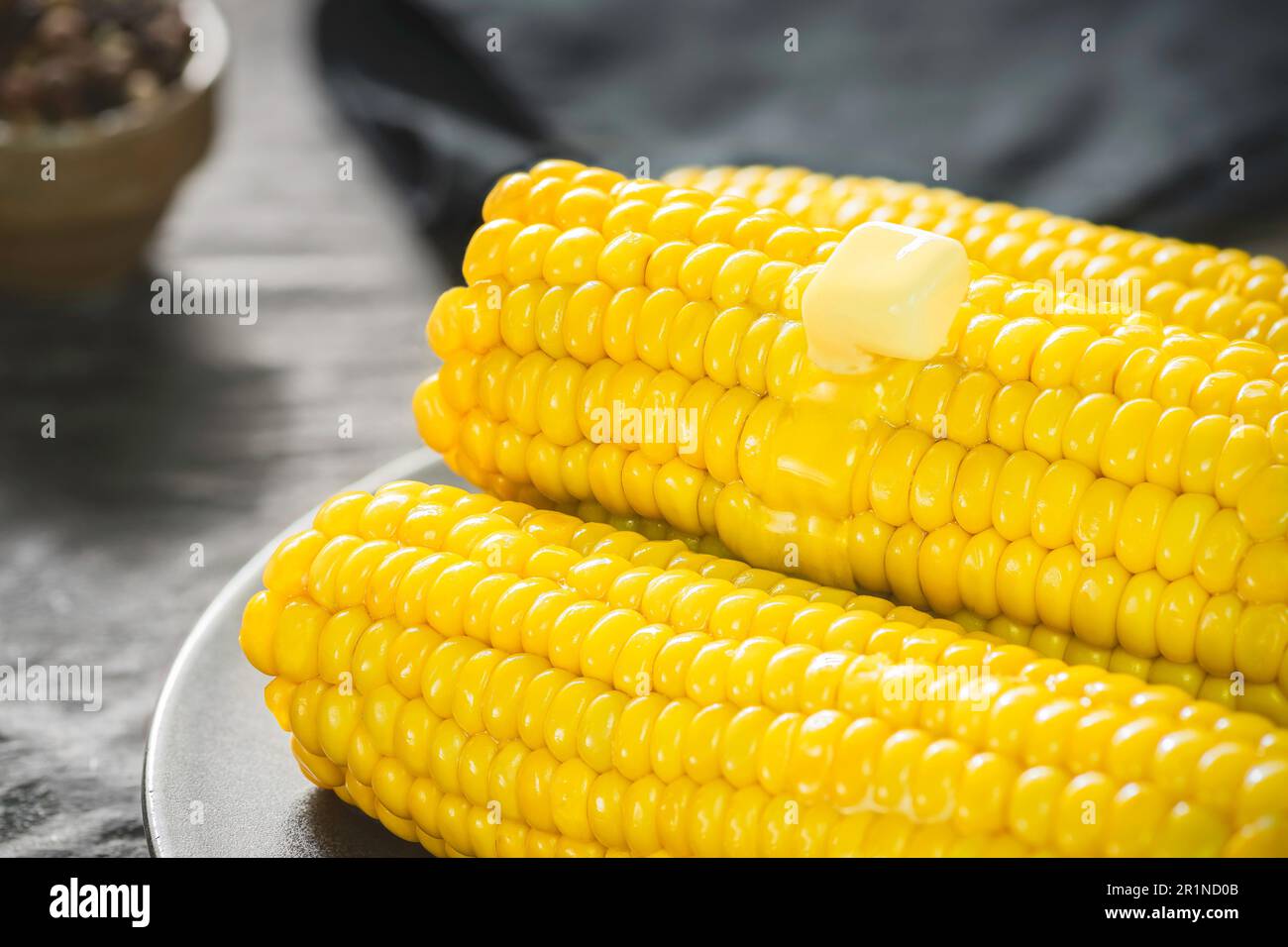 Delicious corn on the cob with melted butter. Close up with copy space. Stock Photo
