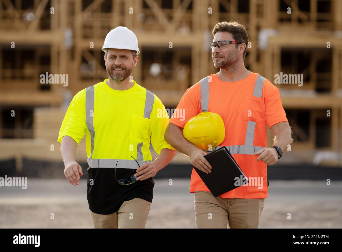 two architect men have construction project on clipboard. photo of ...