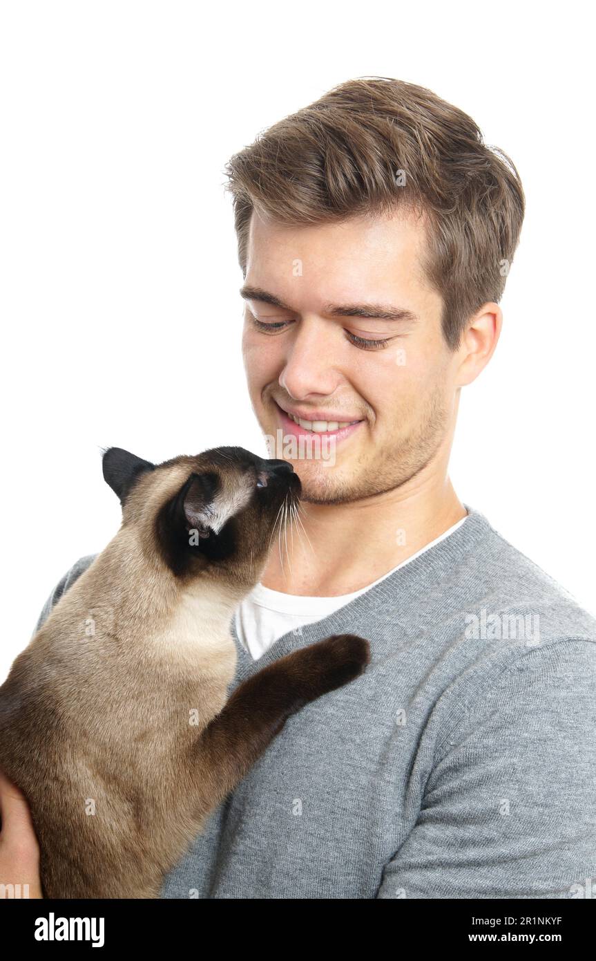 young holding siamese cat Stock Photo