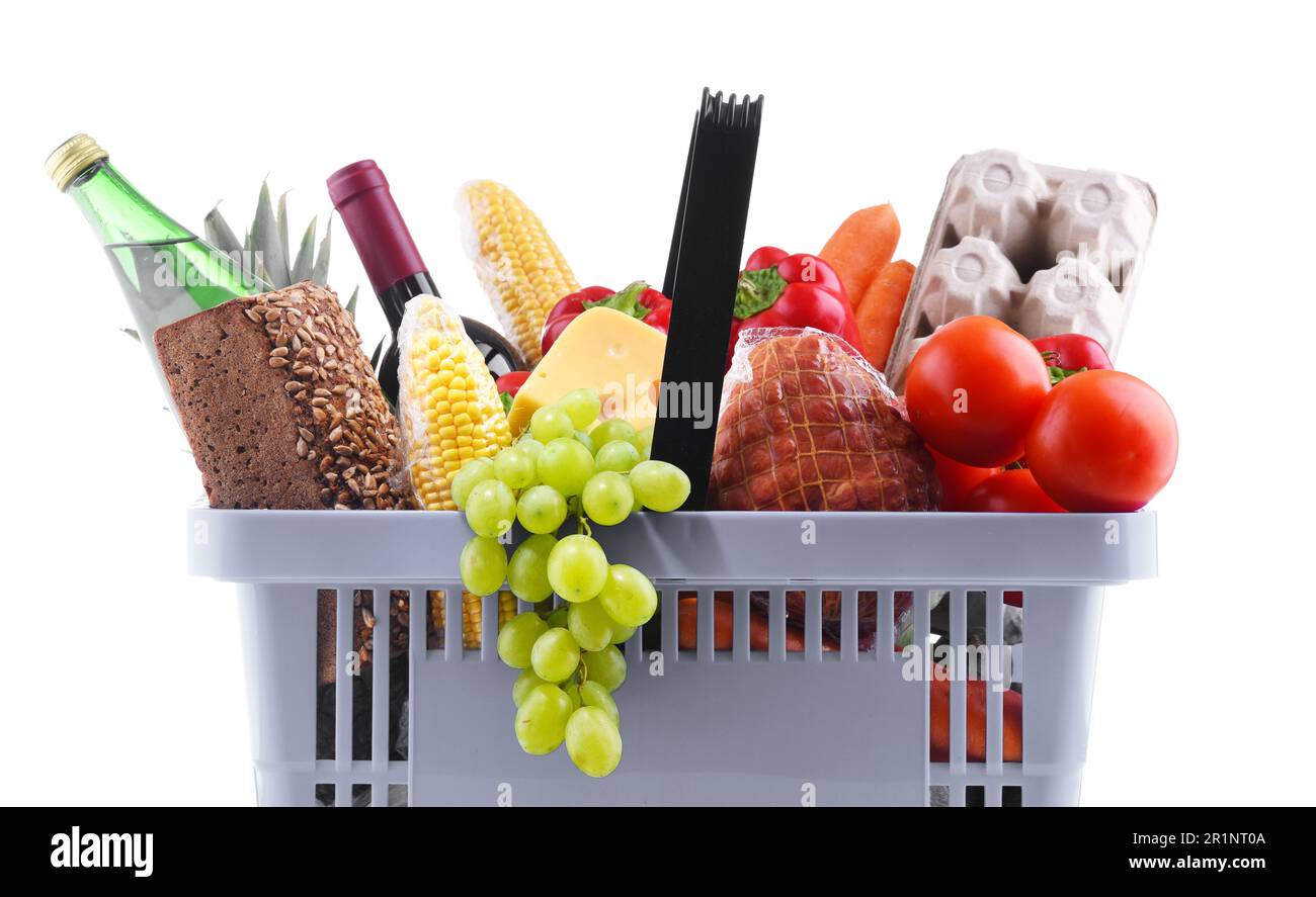 Plastic shopping basket with assorted grocery products isolated on white Stock Photo