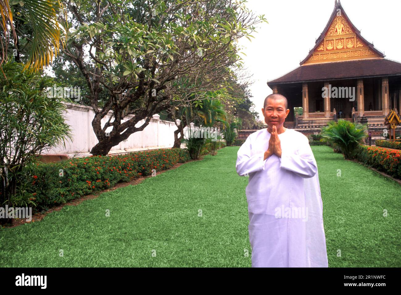 Nun in White Praying at Ho Phrakeo Buddhist Temple Vientiane Laos Stock Photo