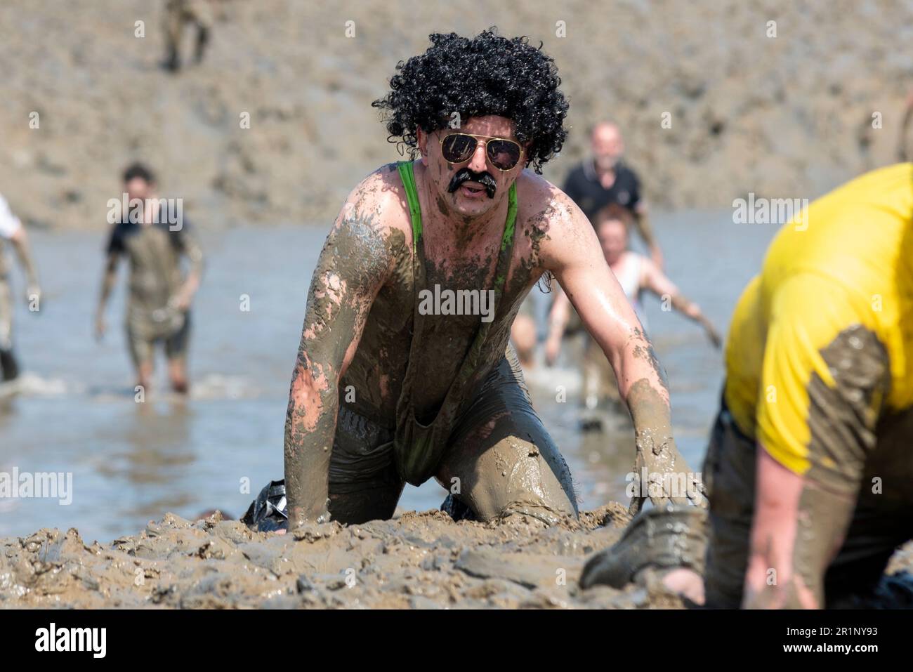 Male in mankini taking part in the Maldon Mud Race in Maldon, Essex, UK, in the mud of the River Blackwater. Traditional charity event. Borat costume Stock Photo