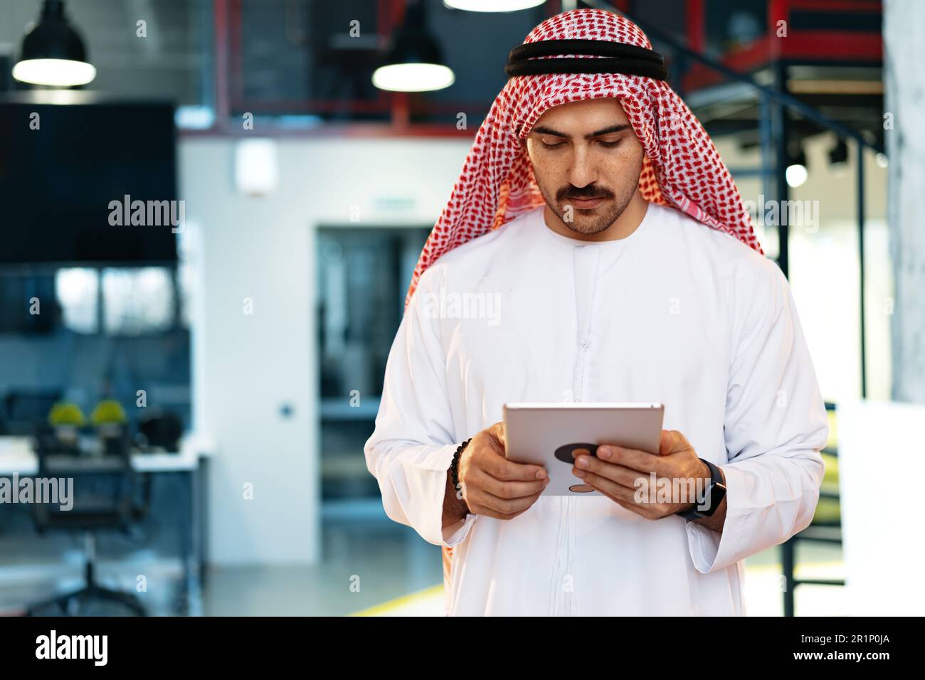 Arab muslim businessman using digital tablet in modern office Stock Photo