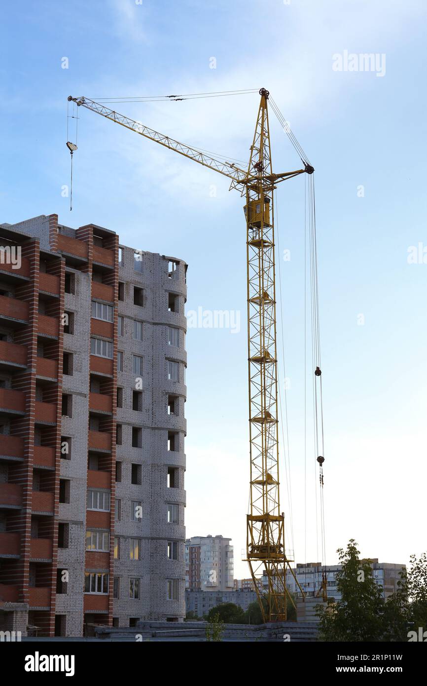 Construction site with tower crane near unfinished building Stock Photo