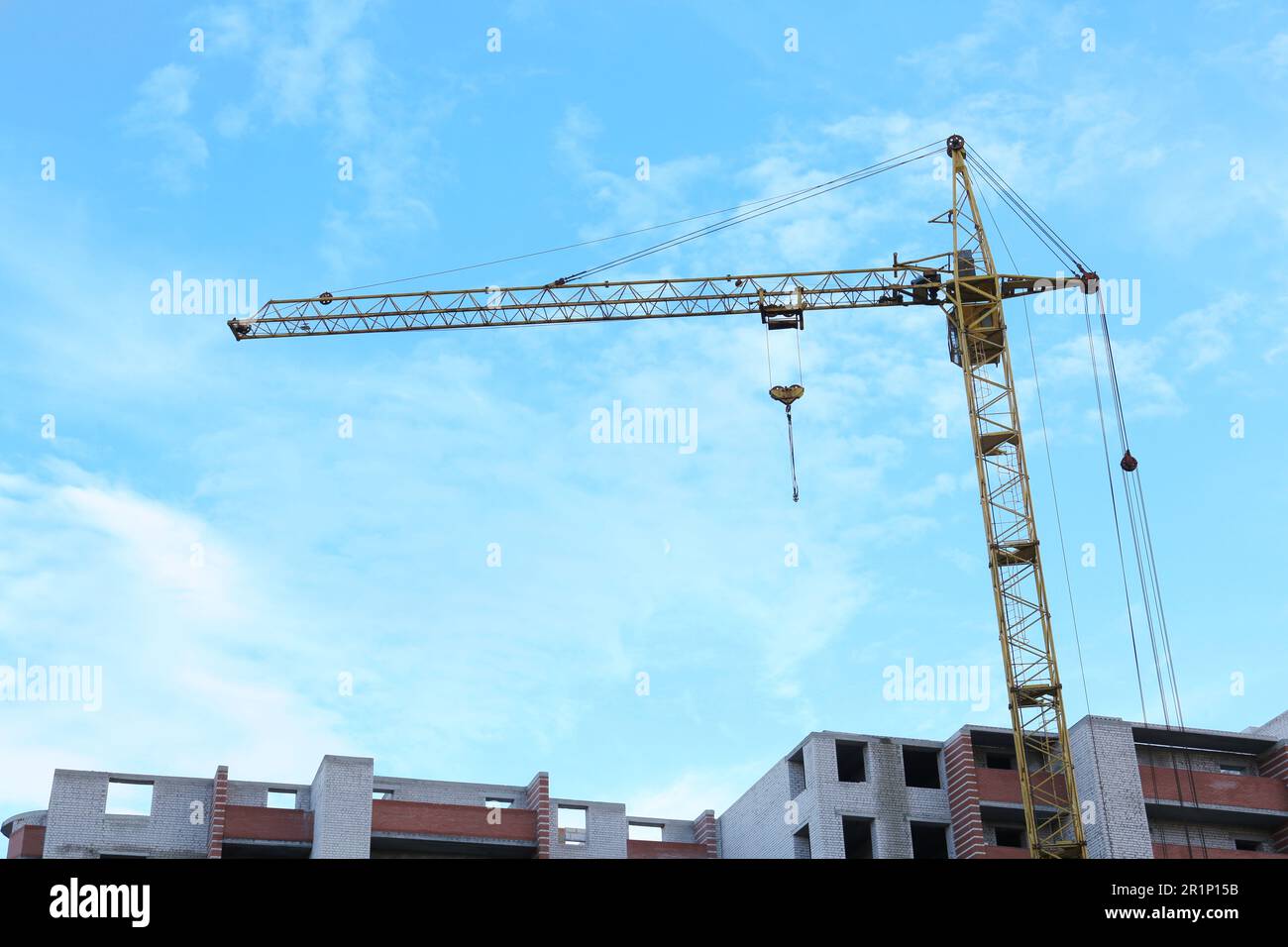 Construction site with tower crane near unfinished building Stock Photo
