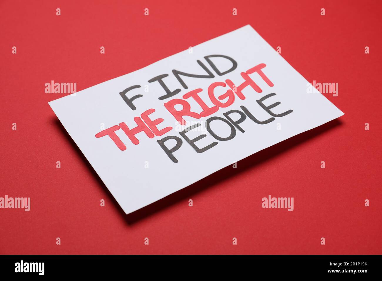 Card with motivational phrase Find The Right People on red background Stock Photo