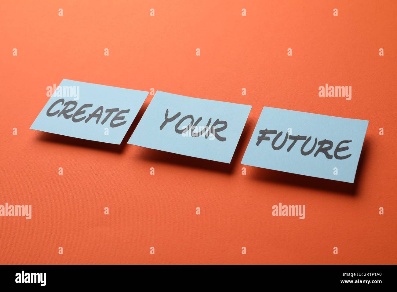 Motivational phrase Create Your Future made of sticky notes with words on orange background Stock Photo